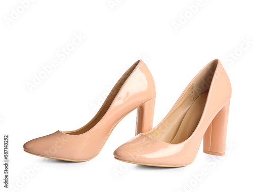 Pair of beige high heeled shoes on white background