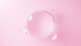 ピンクの背景に浮かぶ複数の水の球体。球体のガラス。（横長）
