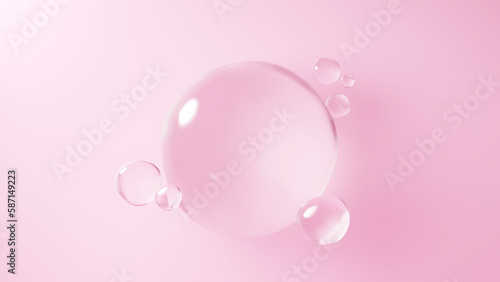 ピンクの背景に浮かぶ複数の水の球体。球体のガラス。（横長） photo