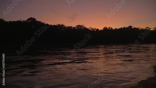 sunset in a tropical forest from a boat in the Amazon, Peru