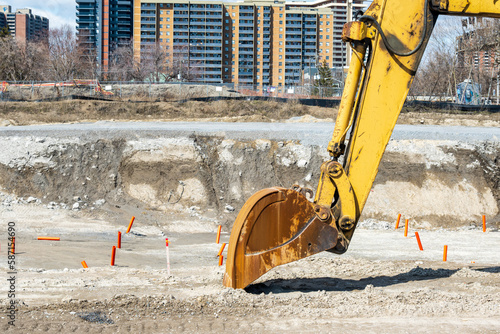 Canvas Print large excavator  bucket shovel parked on site at a large construction project