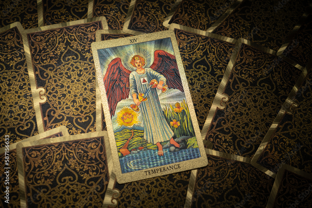 Gold embossed tarot cards on the table. The Major Arcana card The