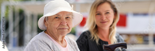 Slika na platnu Senior woman with guardian on walk in summer