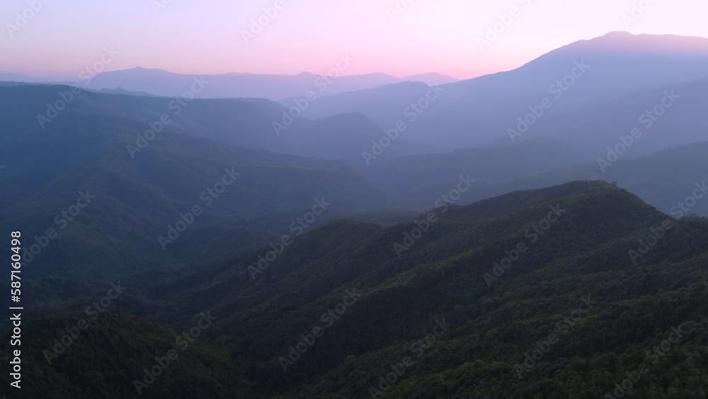 A beautiful aerial flight over the tree covered hills at sunset in the wilderness. A beautiful aerial flight over the tree covered hills at sunset in the wilderness.