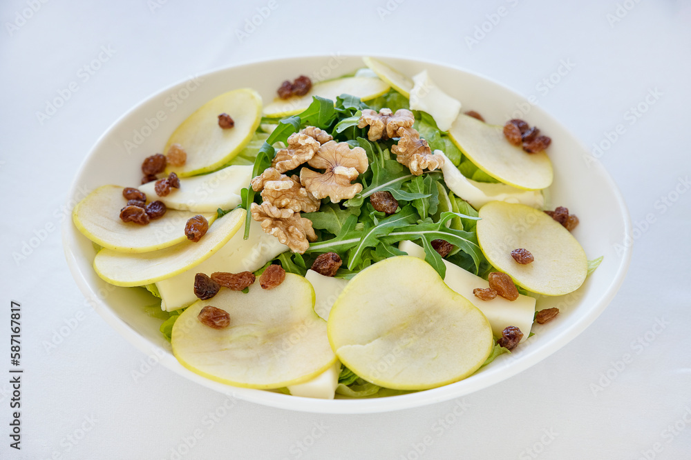 Delicious fresh salad combining flavors and textures with crisp juicy apples for a hint of tanginess, earthy walnuts for a crunch, rocket leaves for a peppery bite and raisins for a touch of sweetness Delicious fresh salad combining flavors and textures with crisp juicy apples for a hint of tanginess, earthy walnuts for a crunch, rocket leaves for a peppery bite and raisins for a touch of sweetness