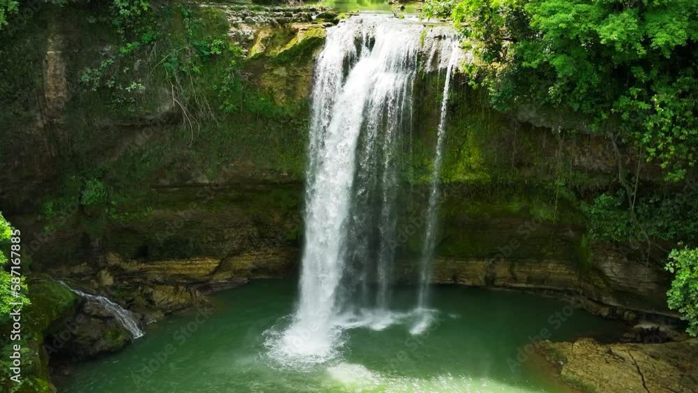 Waterfall in the tropical forest in slow motion. Ben-Ben Falls waterfall in a mountain gorge. Negros, Philippines. Waterfall in the tropical forest in slow motion. Ben-Ben Falls waterfall in a mountain gorge. Negros, Philippines.