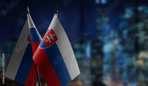 Canvas Print Small flags of the Slovakia on an abstract blurry background