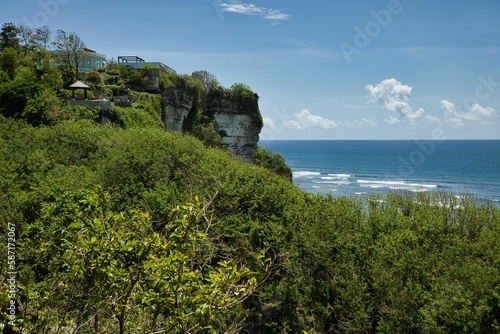 Panoramic view over the coastline with its imposing cliffs overgrown with bushes from Suluban beach on Balin in Indonesia.