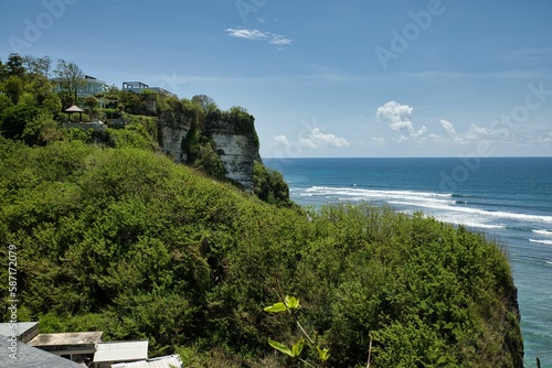 Panoramic view over the coastline with its imposing cliffs overgrown with bushes from Suluban beach on Balin in Indonesia. photo