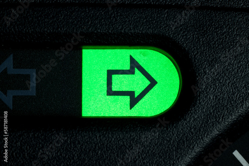 Green turn arrow on car dashboard. Right photo