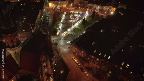 Drone view of Christmas stalls and carousel on the Podgorski Square with St. Joseph's Church in Krakow, Poland at night. photo