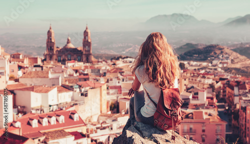 Quadro su tela Tourism in Spain- Woman tourist sitting and looking at panoramic view of Jaen ci