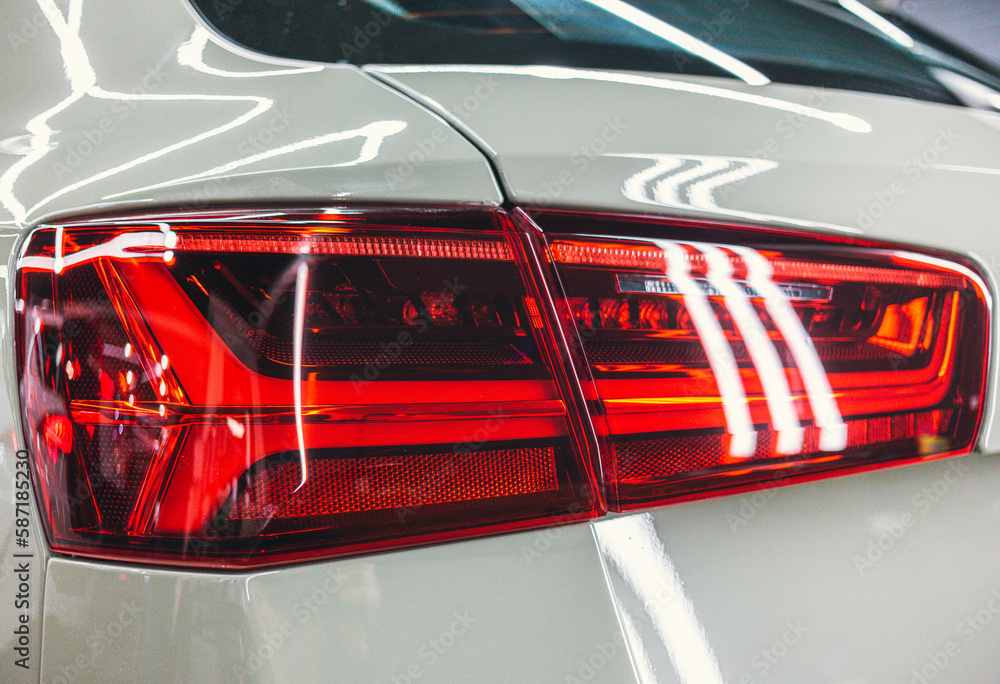 The rear brake light of a modern hatchback full frame. The tail light of the brake light. Rear brake light of a luxury sports car close-up.