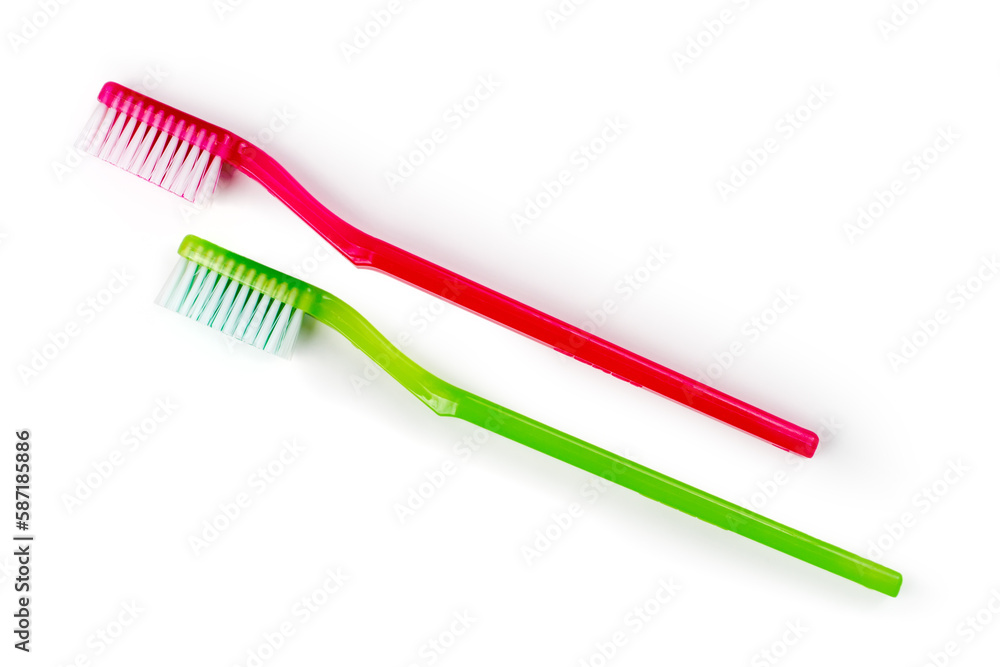 Two simple toothbrushes on a white background. A pair of plastic toothbrushes. Two simple toothbrushes on a white background. A pair of plastic toothbrushes.