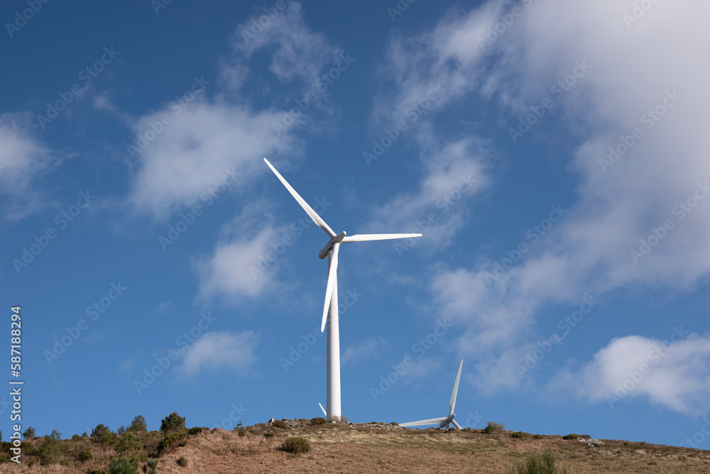 wind turbines on a mountain with blue sky and clouds wind turbines on a mountain with blue sky and clouds
