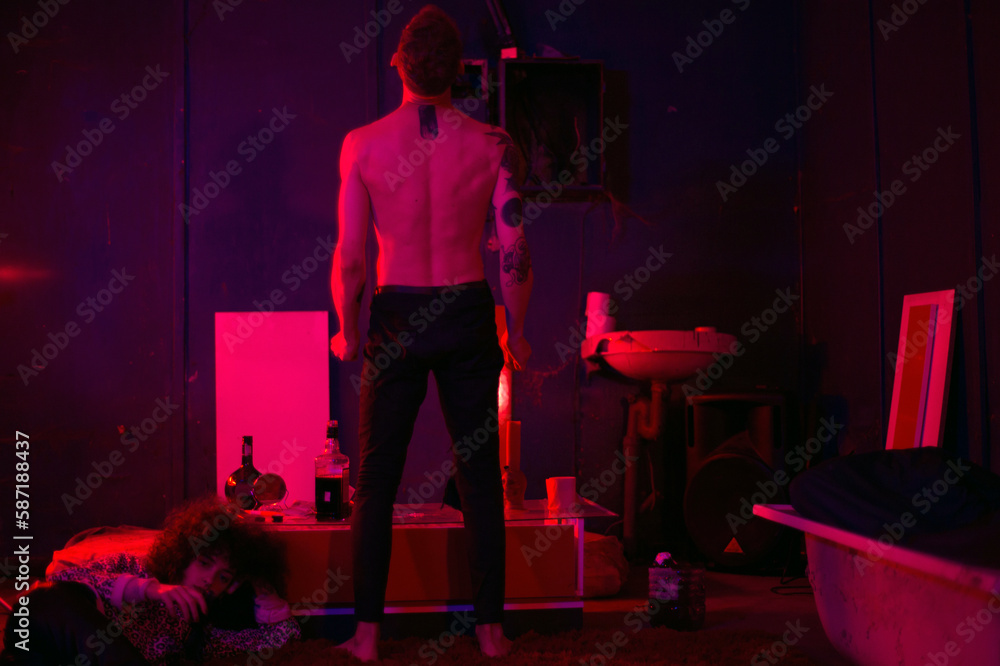 Young man standing with his back backstage movie shoot