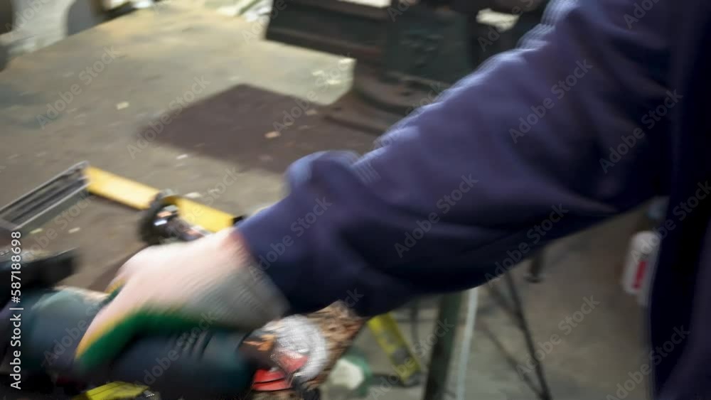 A man works in a garage with iron and tools, men's hobbies A man works in a garage with iron and tools, men's hobbies