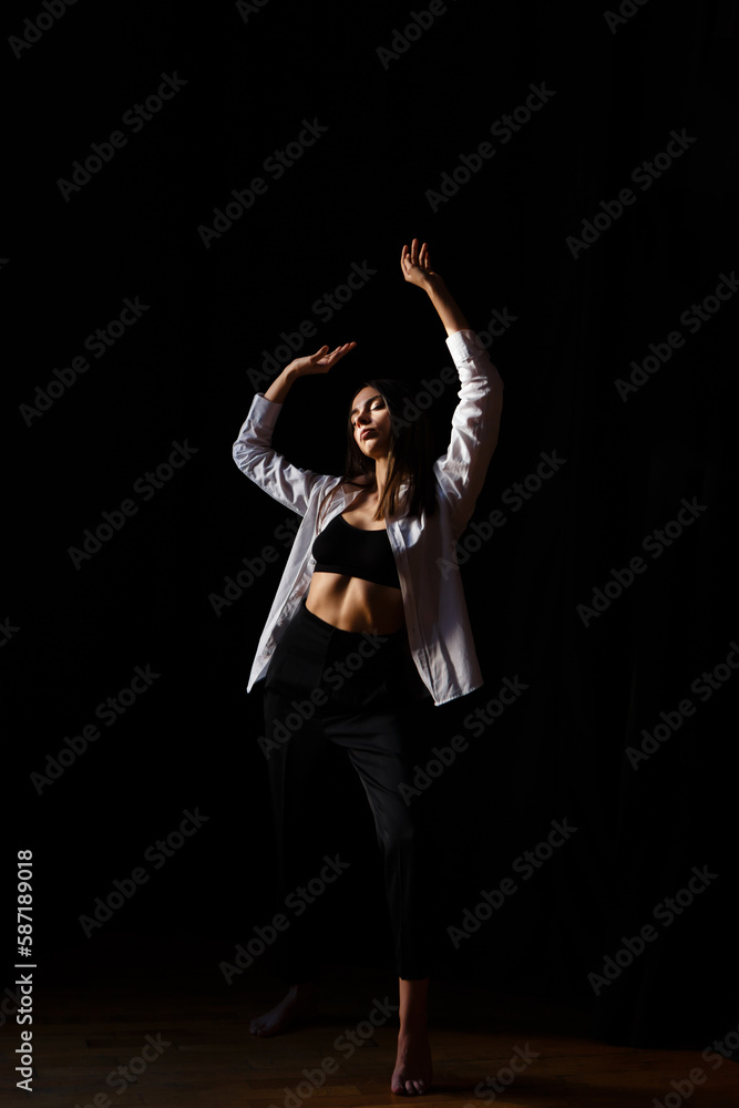 brunette actress dances barefoot in the rehearsal hall of the theater brunette actress dances barefoot in the rehearsal hall of the theater
