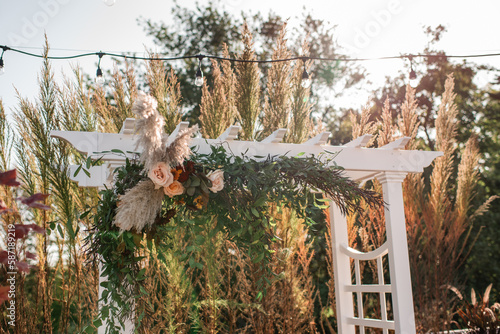 White Wedding Arch/Arbor with Floral Decor and String Lights