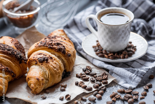 Wallpaper Mural Delicious freshly baked croissants with chocolate and coffee on a dark background. French breakfast. Delicious pastries close-up. The context of a bakery with delicious bread. Confectionery products. Torontodigital.ca