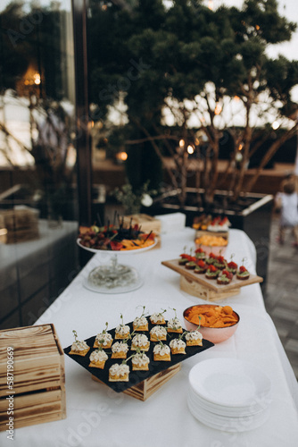 table setting for dinner with fruit on the summer terrace