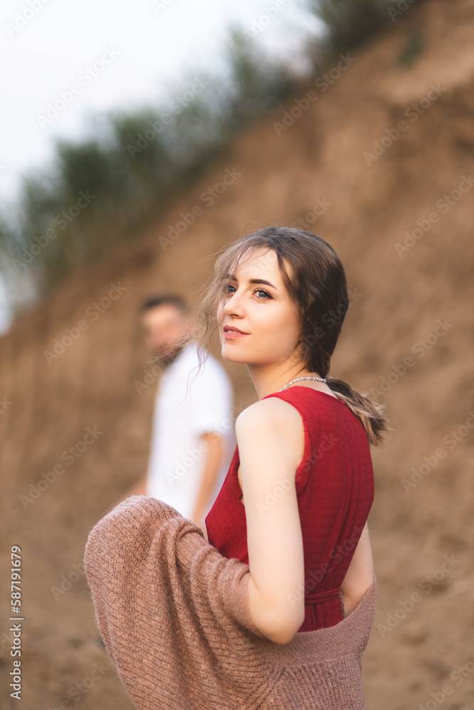 A girl and a boy play the guitar in the field. A romantic date. Couple in love spending time together. The relationship of two lovers. A girl and a boy play the guitar in the field. A romantic date. Couple in love spending time together. The relationship of two lovers.