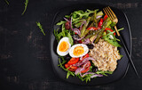 Breakfast oatmeal porridge with boiled egg, cherry tomatoes, asparagus and arugula. Healthy balanced food. Top view, overhead