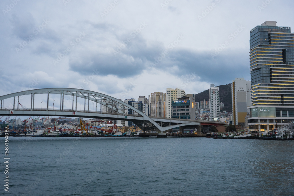 Busan Sea Port city view and Busan bridge during winter evening cloudy day at Jung-gu , Busan South Korea : 9 February 2023 Busan Sea Port city view and Busan bridge during winter evening cloudy day at Jung-gu , Busan South Korea : 9 February 2023