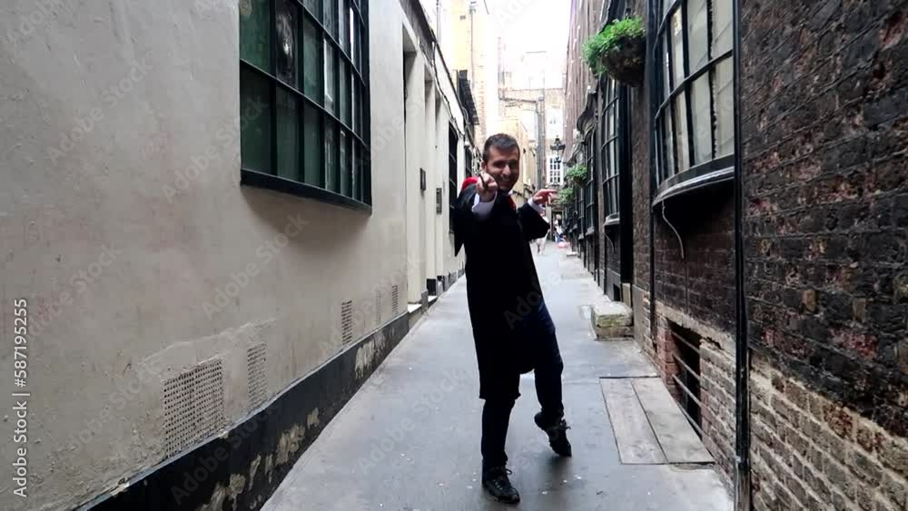 Man dressed up like Harry Potter using a wand in Goodwin's Court, London. Slowmo Man dressed up like Harry Potter using a wand in Goodwin's Court, London. Slowmo