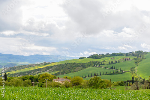 Landscape view of the Italian countryside with rain clouds and a serpentine road
