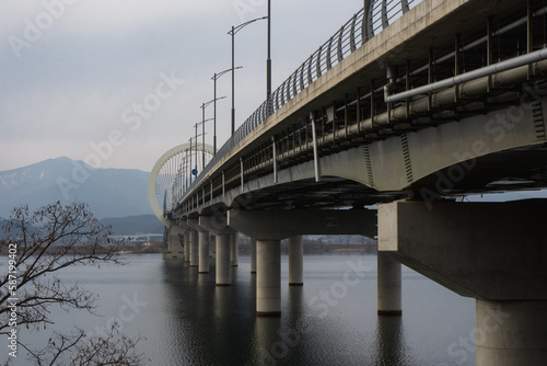 Chuncheon bridge over Soyang river with mountain and city view during winter afternoon at Chuncheon , South Korea : 11 February 2023
