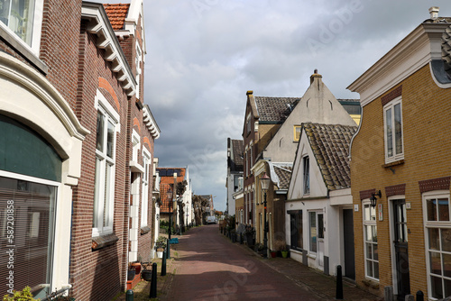 Old houses in the Dorpsstraat in village Moordrecht as part of the Dyke along river Hollandsche IJssel photo
