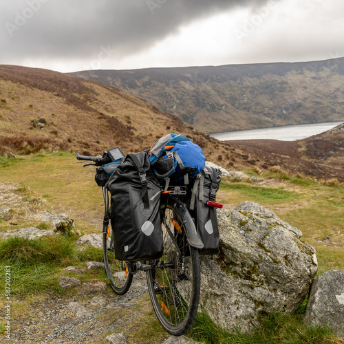 a Bike packer bike resting on mountainous landscape photo