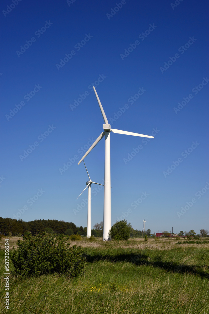 An image of windturbine generator in the blue sky background An image of windturbine generator in the blue sky background