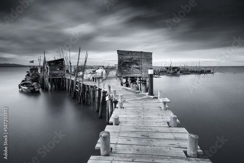 walkways of a pier and boats photo