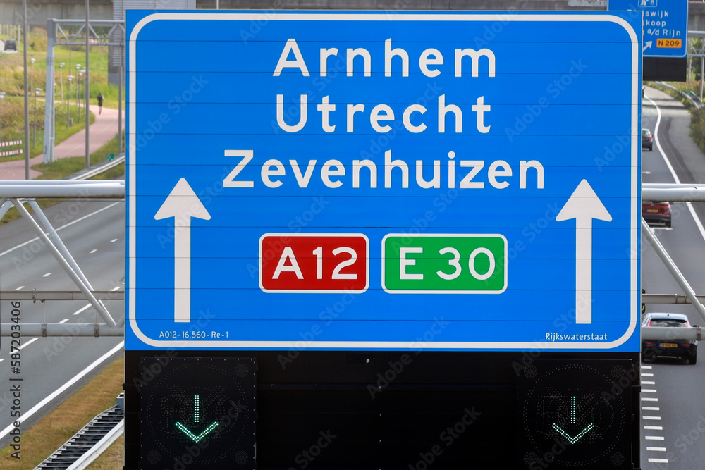 Blue signpost on the highway A12 direction to Arnhem, Utrecht and Zevenhuizen