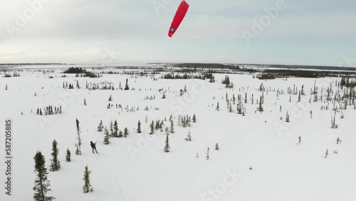 Drone footage of a skier para-skiing with a parachute on a windy winter day in Kenai, Alaska. photo