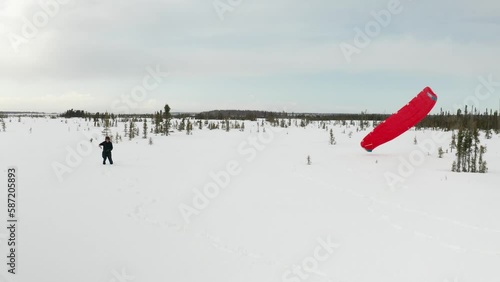 Drone footage of a skier para-skiing with a parachute on a windy winter day in Kenai, Alaska. photo