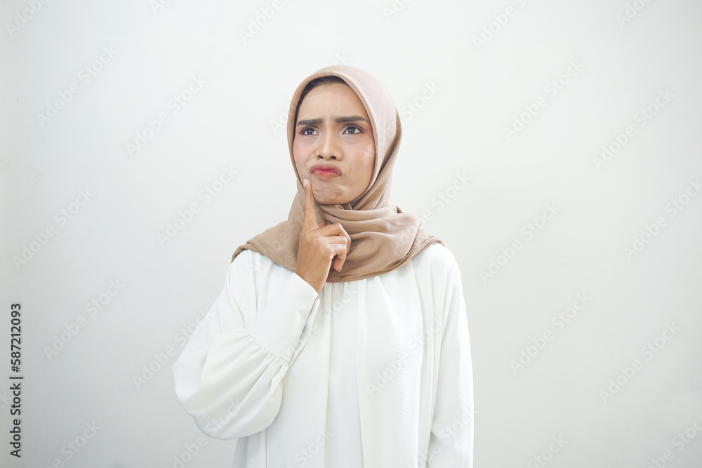 Portrait of thinking young Asian woman looking up and touch chin isolated on over white background Portrait of thinking young Asian woman looking up and touch chin isolated on over white background