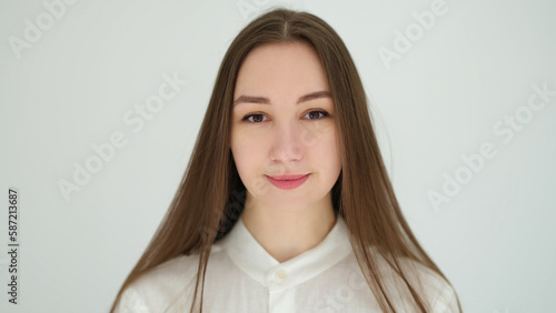 Portrait of young caucasian woman with long hair on white background. Healthy lifestyle concept