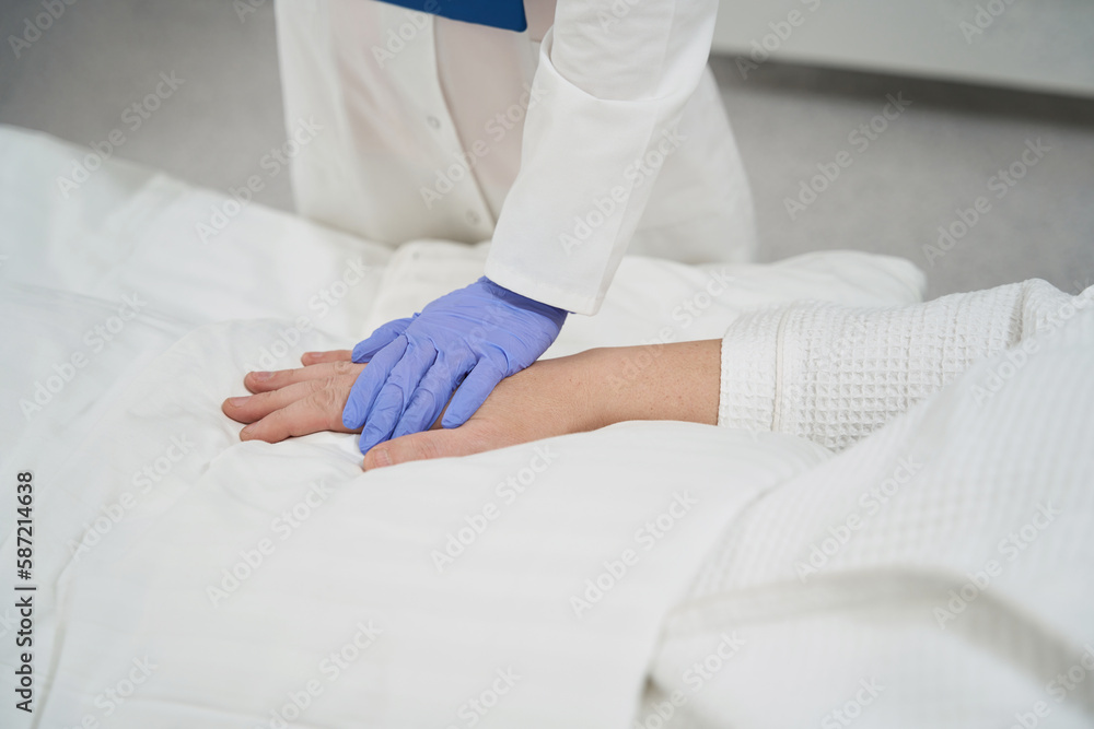 Therapist in the white uniform is visiting the sufferer in the hospital Therapist in the white uniform is visiting the sufferer in the hospital