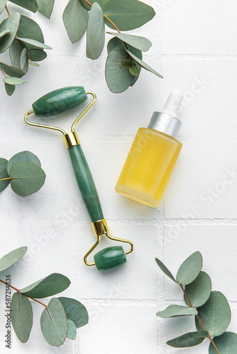 Spa treatment concept. natural spa cosmetics products with eucalyptus oil, massage jade roller, eucalyptus leaf.