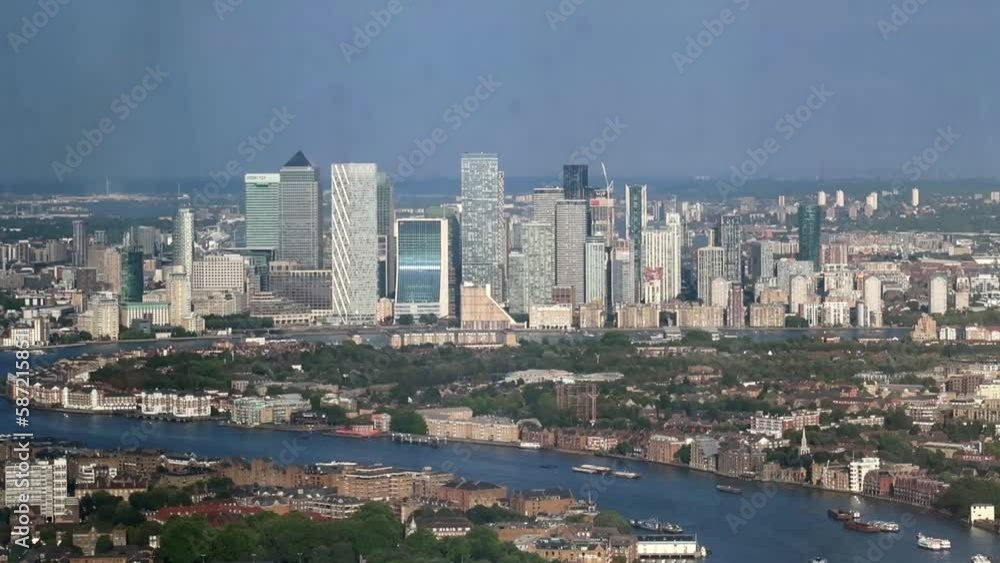 View of Canary Wharf with tall buildings in front of Thames River meander. London, UK View of Canary Wharf with tall buildings in front of Thames River meander. London, UK