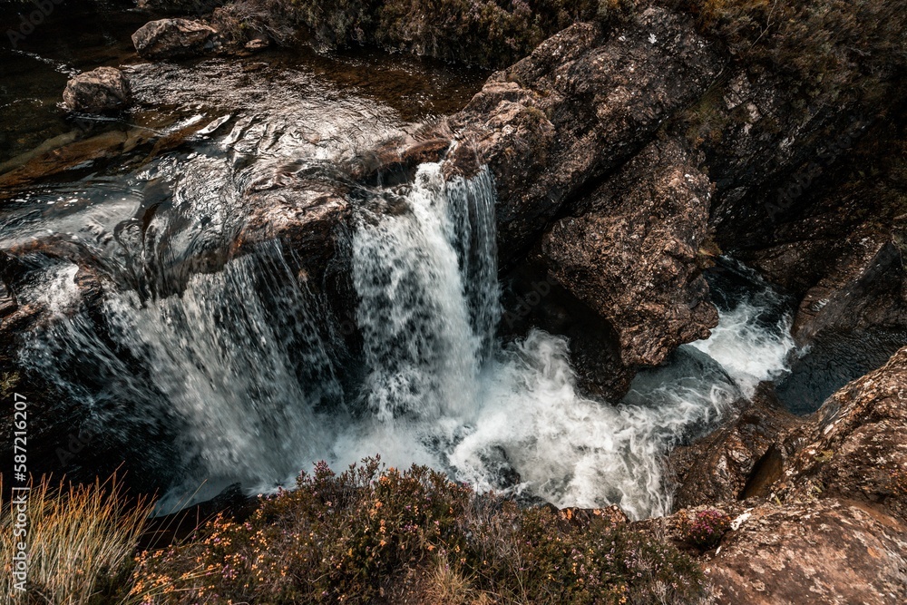 High-angle of waterfall formation by falling rivers from steep rocks in the Isle of Skye, Scotland High-angle of waterfall formation by falling rivers from steep rocks in the Isle of Skye, Scotland