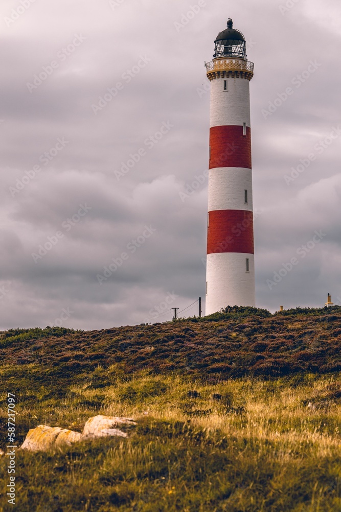 Tarbat Ness Lighthouse in Scotland against a cloudy sky