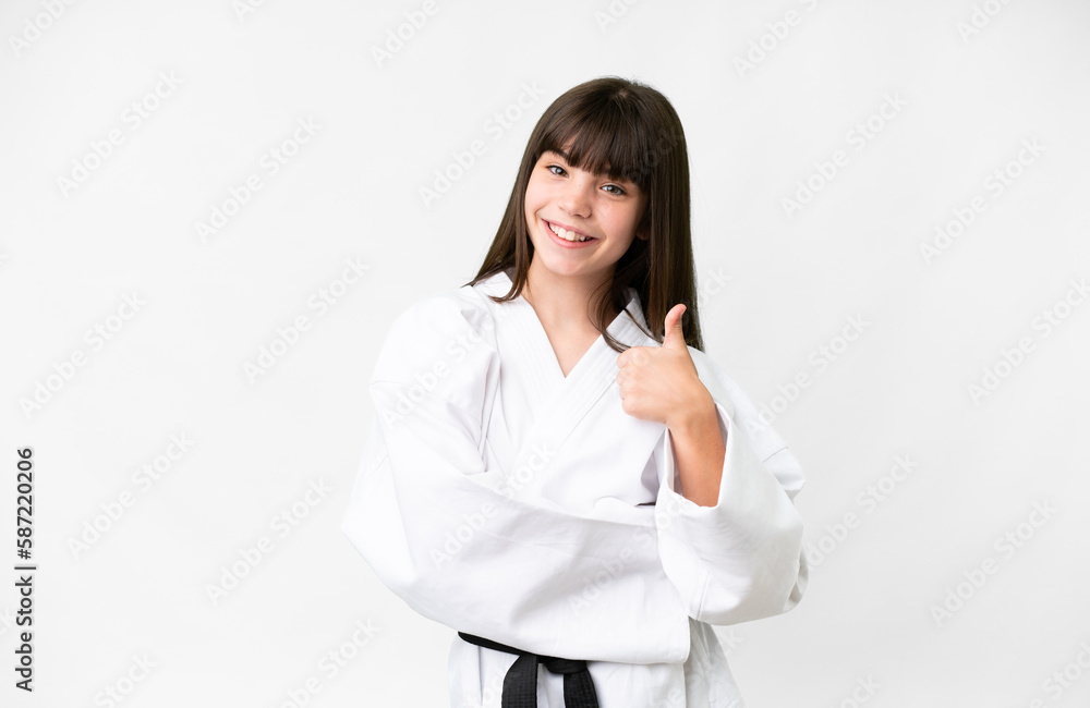 Little caucasian girl over isolated white background with thumbs up because something good has happened Little caucasian girl over isolated white background with thumbs up because something good has happened