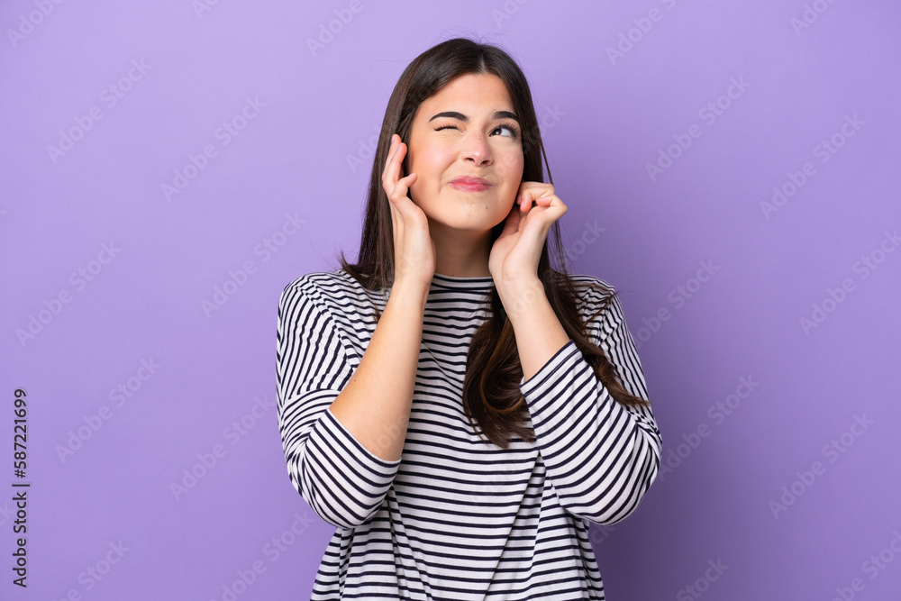 Young Brazilian woman isolated on purple background frustrated and covering ears Young Brazilian woman isolated on purple background frustrated and covering ears