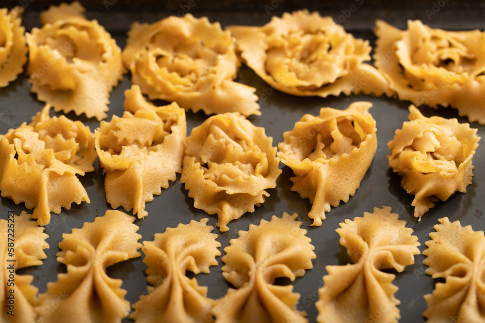 Zooming into culinary finesse: the delicate touch of hands crafting chebakia dough into delightful, unique shapes Zooming into culinary finesse: the delicate touch of hands crafting chebakia dough into delightful, unique shapes