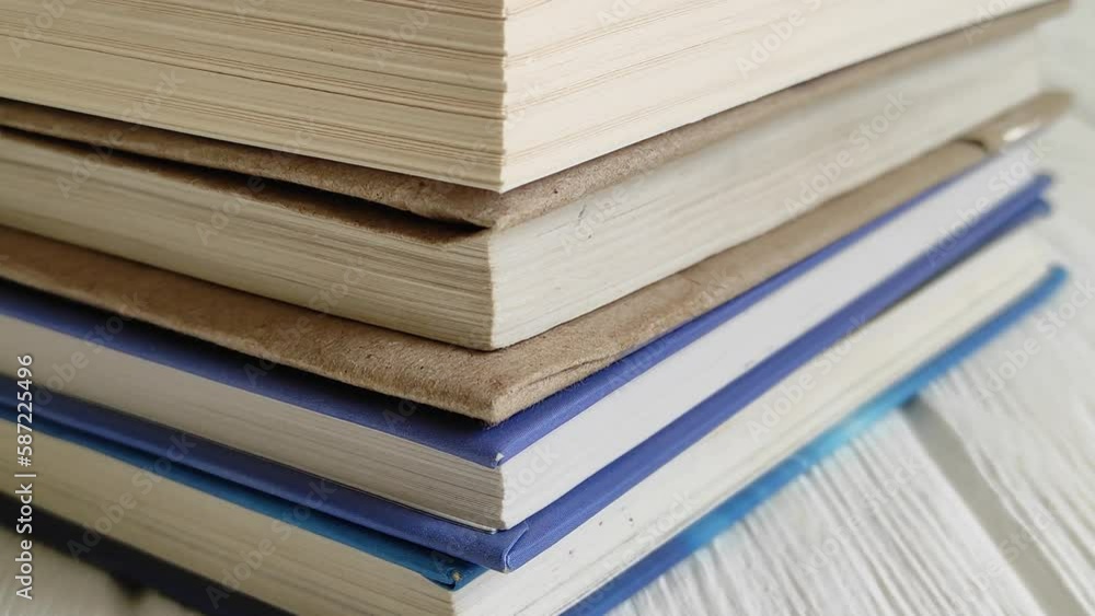 Stack of old books with one volume added on top Stack of old books with one volume added on top