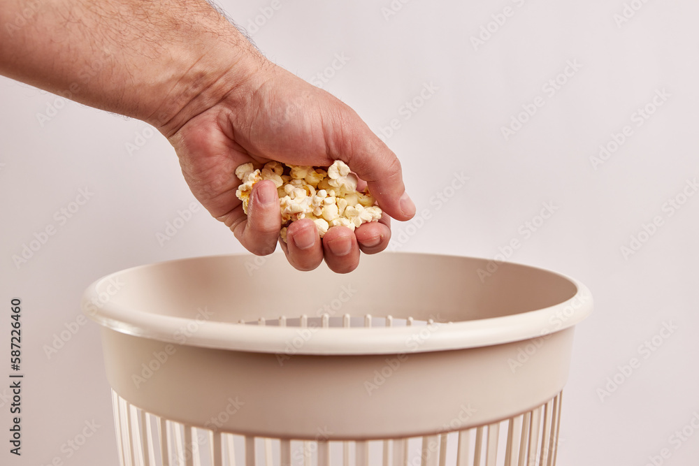 Expired popcorn is thrown into the trash can. Disposal and recycling of